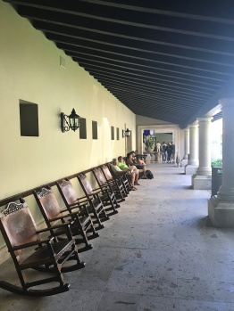 The main lobby building has a row of rocking chairs outside. This is where you can wait for a cab or your shuttle bus.