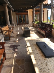 Outdoor seating and fire pit tables outside the bar by the main pool